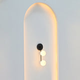 Two-light globe wall sconce illuminated with soft warm ambient light for bedroom, hallway, vanity, or living room interiors