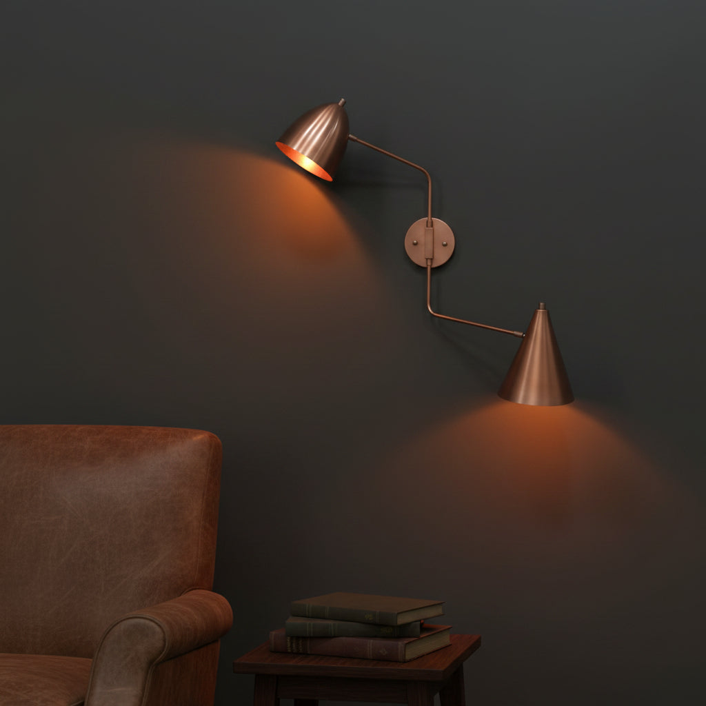 Solid brass dual shade wall light with adjustable arms and warm downward lighting for bedrooms and reading corners