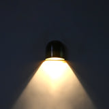 Closeup of dual tone brass wall sconce showing dark aged upper patina and warmer brass lower section