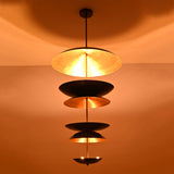 Eclipse Cascade Chandelier illuminated with warm ambient light emphasizing brass interior reflective shades