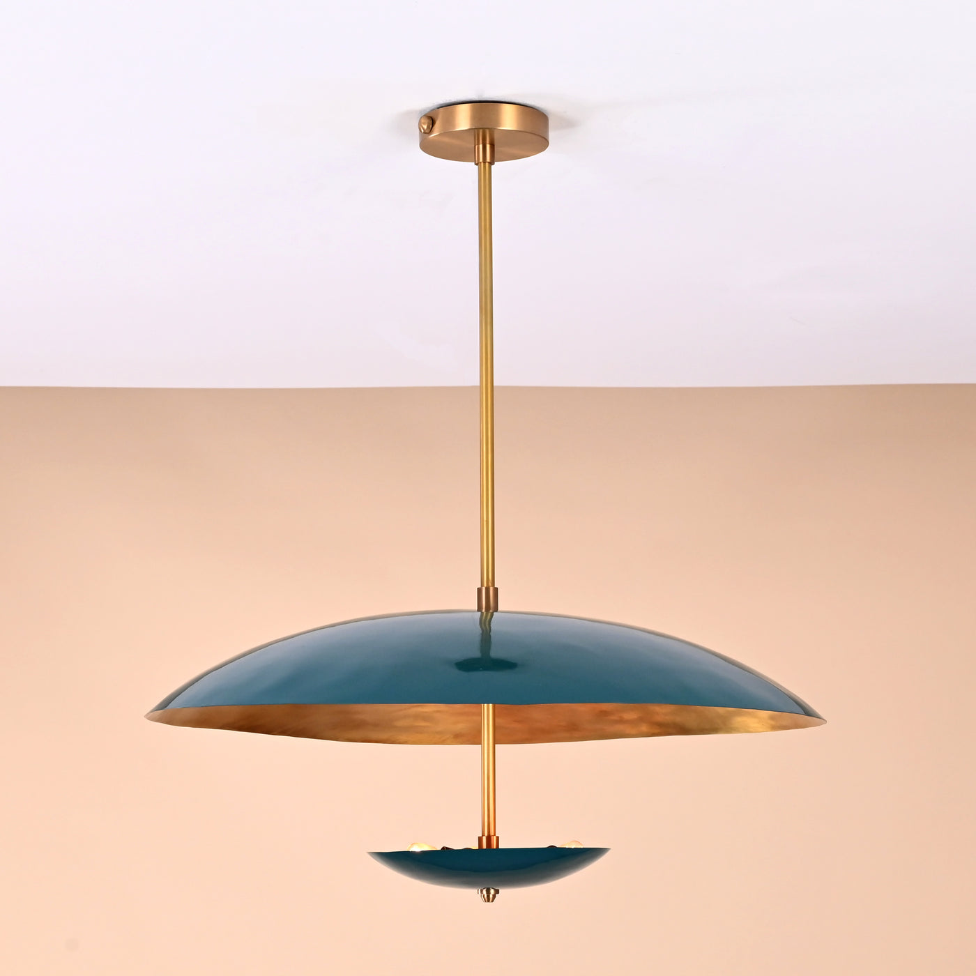 Front view of handcrafted emerald green brass chandelier with golden interior finish and elegant dual-bowl silhouette