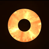 Illuminated view from below showing warm golden glow of emerald green brass pendant light creating soft ambient circle effect