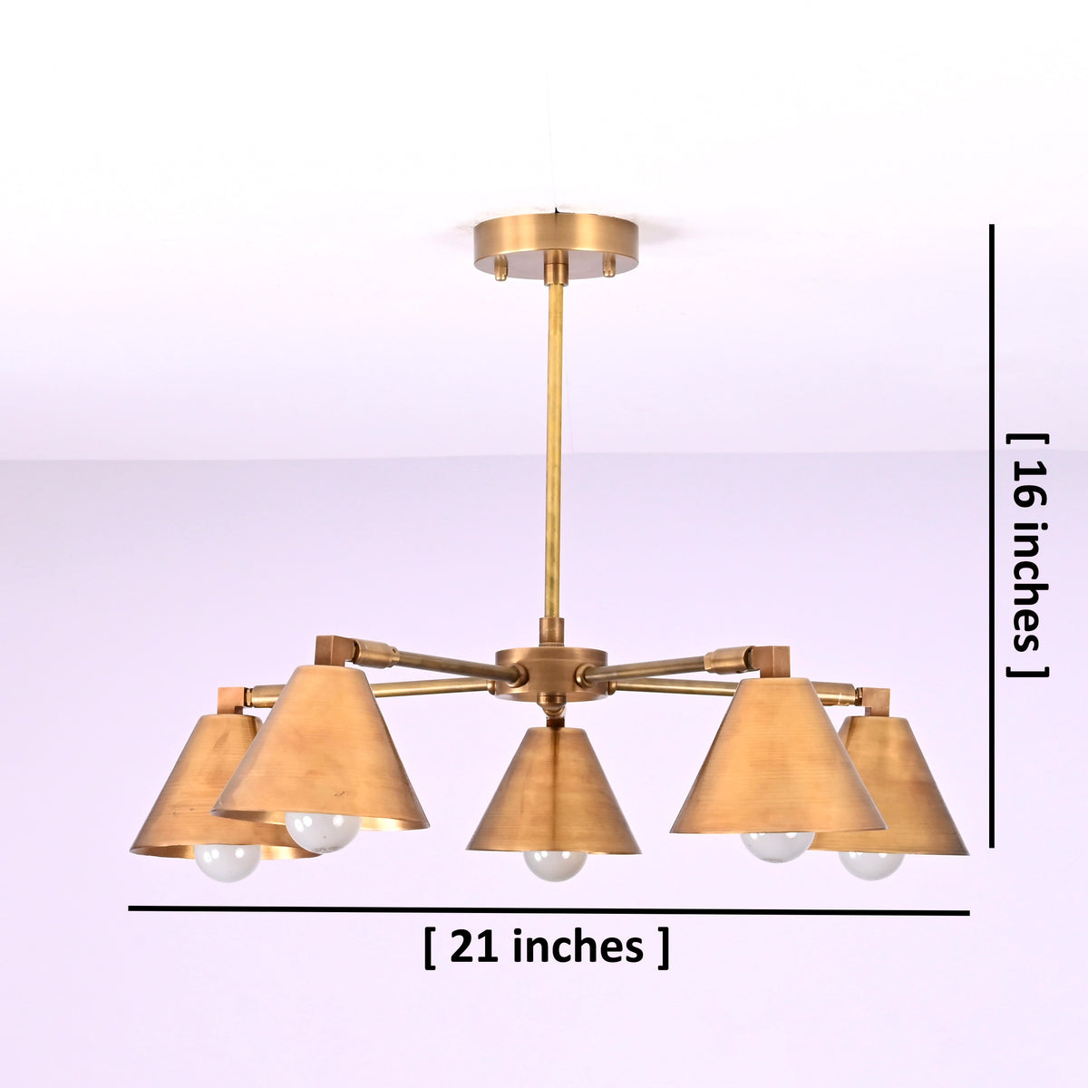Five-light brushed brass chandelier showing 21-inch width and 16-inch height dimensions with cone-shaped shades.