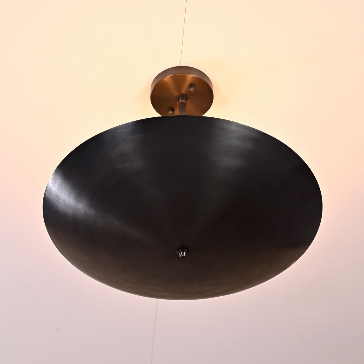 Upward view of 5-light blackened brass flushmount ceiling chandelier