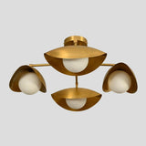 Bottom view of flushmount brass chandelier showing symmetrical arrangement of three bowl-shaped shades with white bulbs
