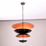Side view of tiered disc chandelier with black brass outer and warm copper patina interior