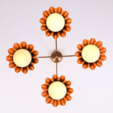 Top view of four-light brushed brass chandelier with scalloped bowl shades and warm diffused glow.