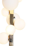 Close-up of frosted glass globes on polished brass vertical chandelier showing fine craftsmanship and finish detail.