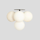 Side view of handmade globe chandelier – brass ceiling fixture with frosted glass globes for modern interiors
