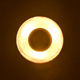 Top glowing view of brass disc ceiling light forming an elegant golden halo effect on ceiling