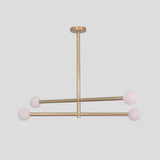 Contemporary gold brass chandelier with frosted glass globes, handmade linear ceiling fixture.