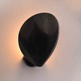 Closeup of halo glow wall sconce showing soft rear illumination around the curved front shield