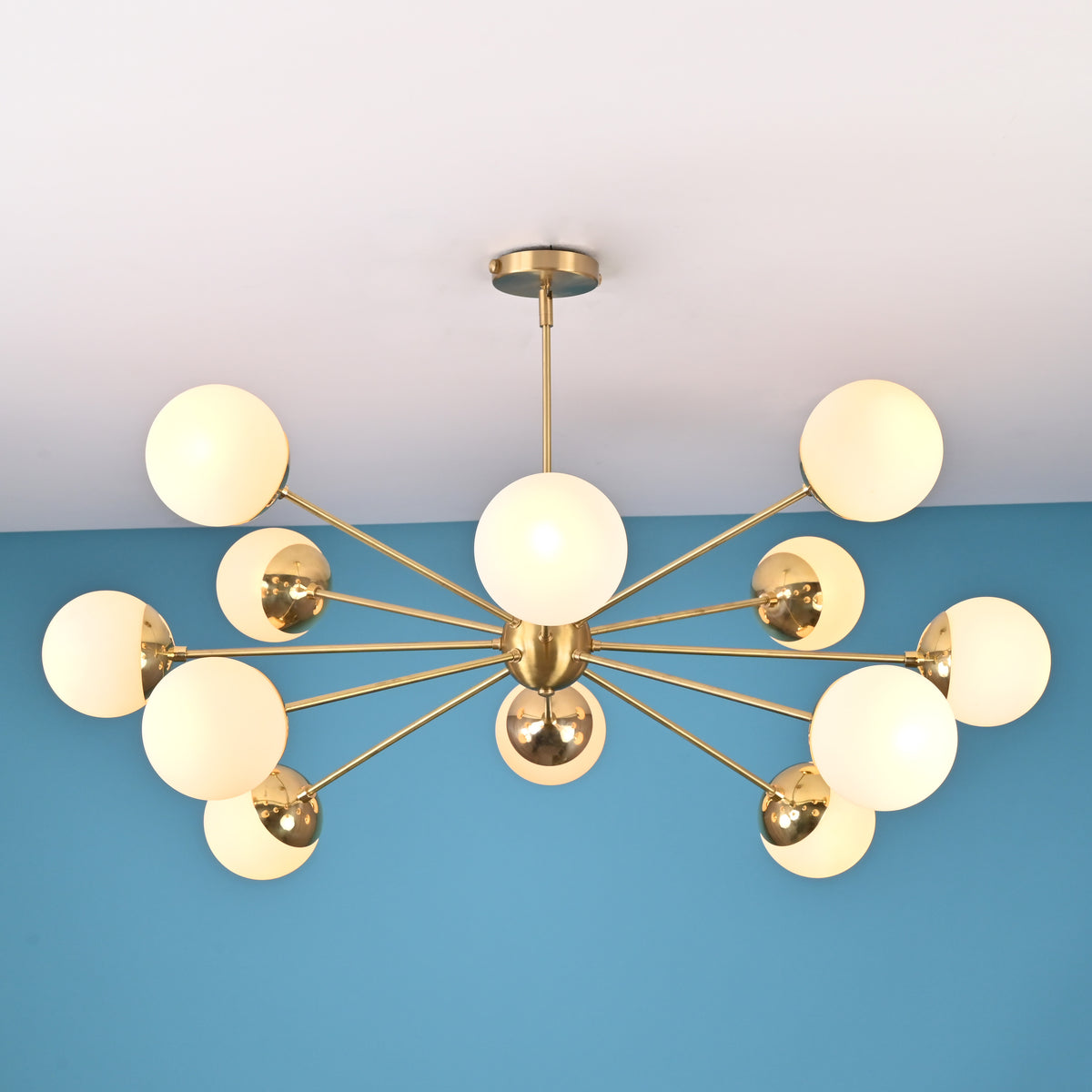 Handcrafted solid brass 12 light sputnik chandelier with opal globe shades and sculptural arms