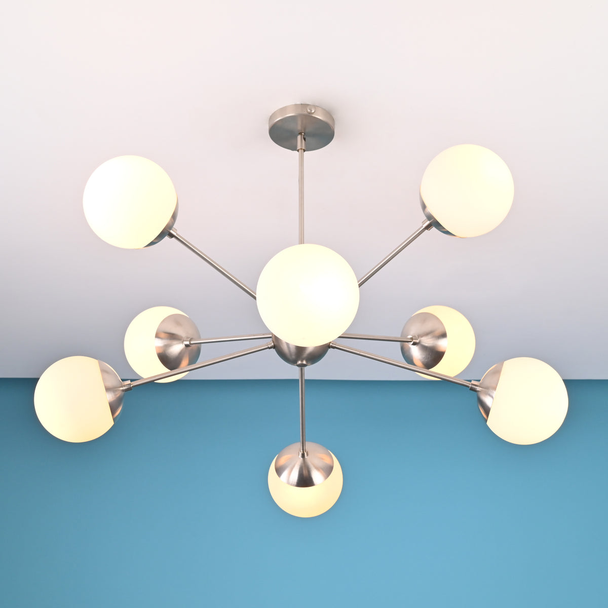 Handcrafted solid brass 8 light sputnik chandelier with opal globe shades and sculptural arms