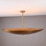 Artisan-crafted brass bowl ceiling light with elegant suspended rod and minimalist disc profile.