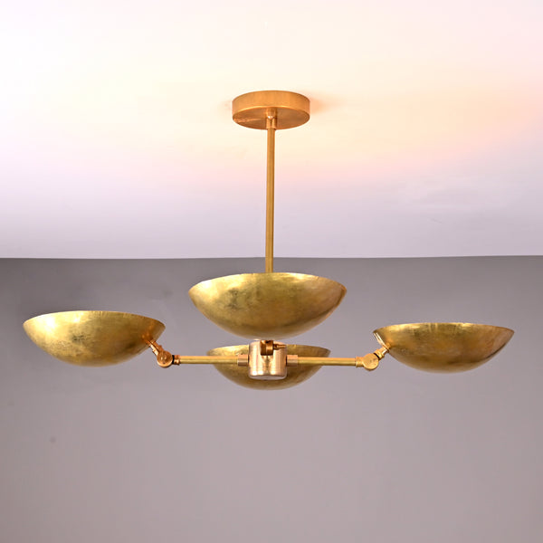 Front angle view of handcrafted solid brass chandelier with four hammered bowl shades and central brass rod suspension.