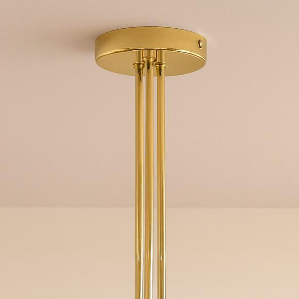 Handcrafted brass ceiling canopy and rod detail of a mid-century modern bowl glass chandelier