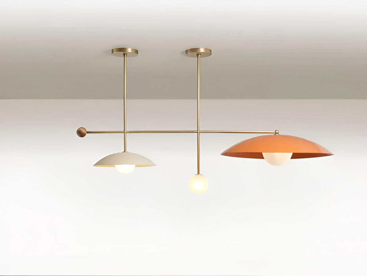 Handcrafted solid brass disc chandelier providing soft ambient glow, designed for modern living spaces with sculptural elegance and balanced proportions.