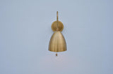 Front view of handcrafted brass dome sconce highlighting its curved dome shape and sleek wall mount in brushed brass finish.