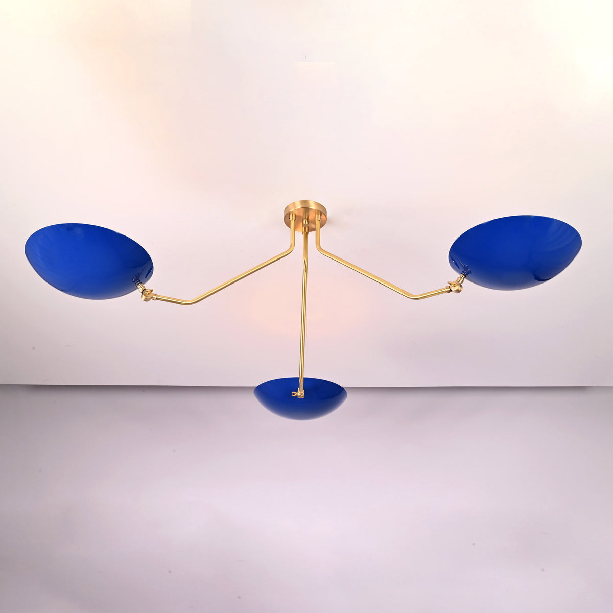 Handcrafted solid brass flush mount ceiling light with sculpted arms and blue bowl shades