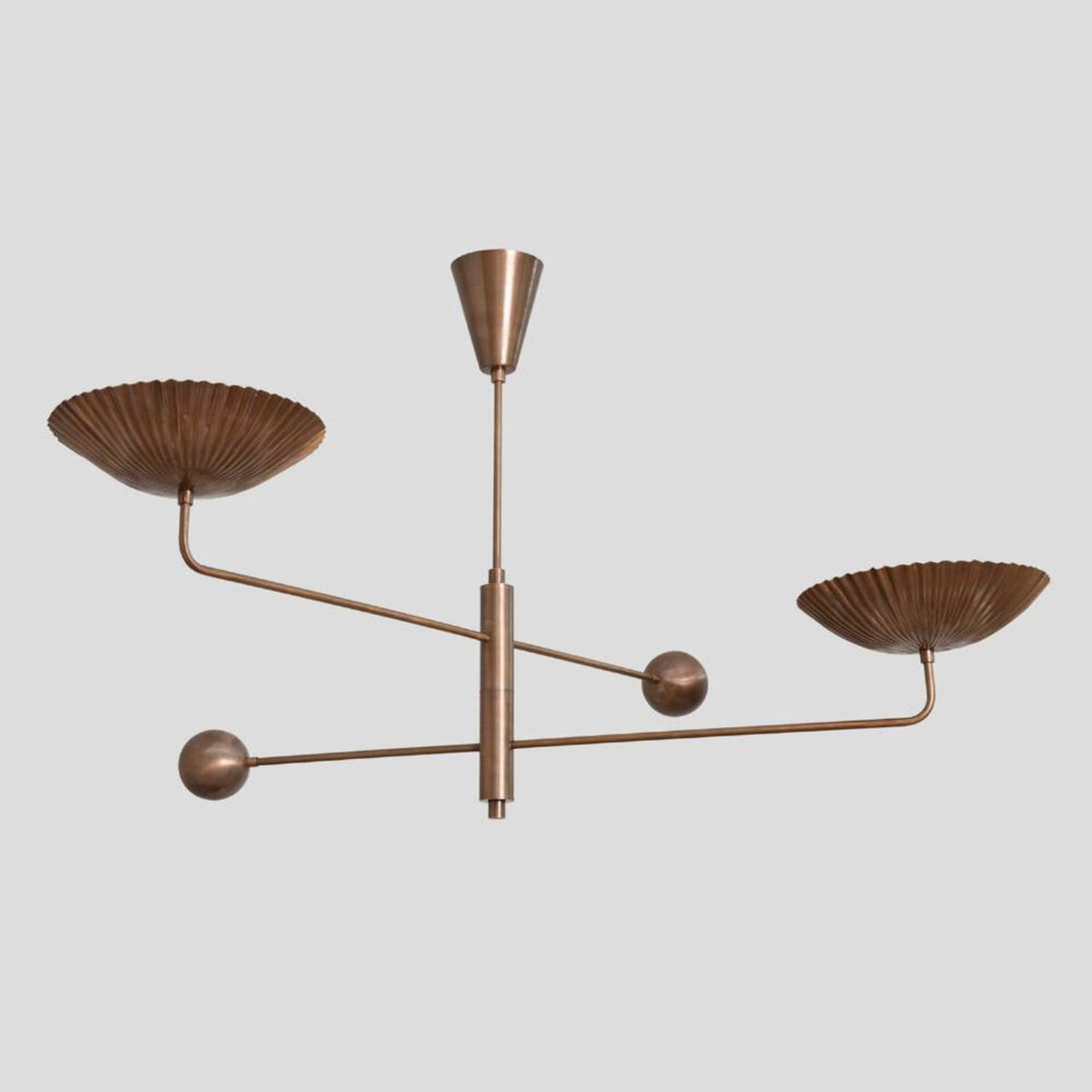 Handcrafted brass chandelier with fluted bowl-shaped shades and linear arms, unique ceiling light for dining or living rooms.
