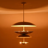 Handmade layered brass pendant with 8-light arrangement casting golden radiance