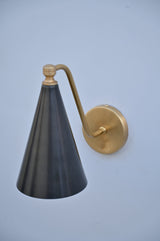 Handmade blackened brass wall light with golden brass arm, designed by Brass Leaf Studio for modern interiors.
