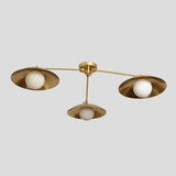 Overhead view of handmade brass 3-light chandelier with minimalist design and lacquer-coated bowl shades for elegant ambient lighting.
