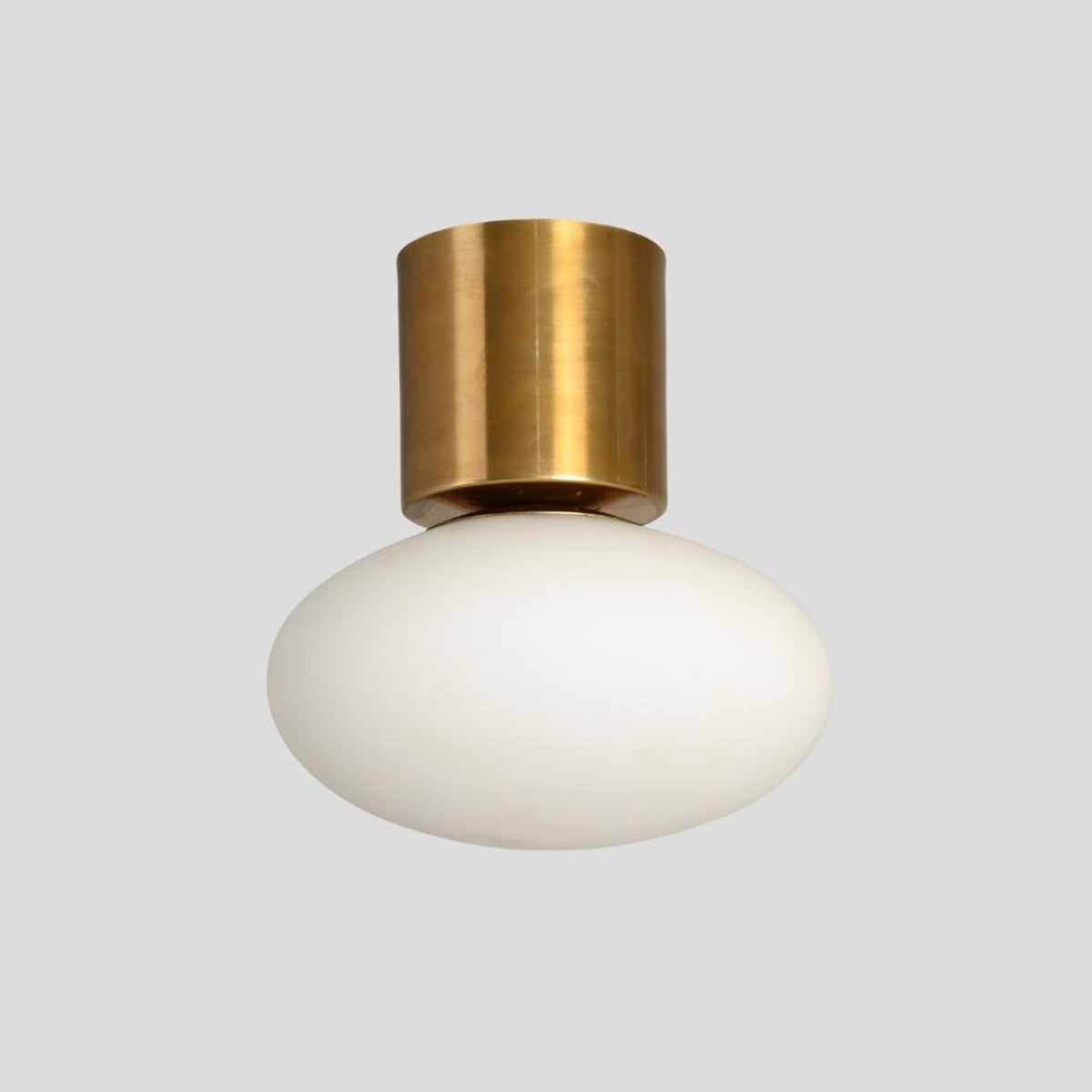 Handmade brass flush mount ceiling light with frosted glass shade, minimalist industrial style by Brass Leaf Studio.