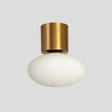 Handmade brass flush mount ceiling light with frosted glass shade, minimalist industrial style by Brass Leaf Studio.