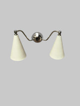 Handmade brass dual cone wall sconce with minimalist design, featuring polished body and ivory cone shades.