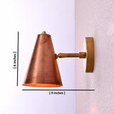 Handmade brass wall light with a tapered copper cone shade, mounted on circular brass backplate.