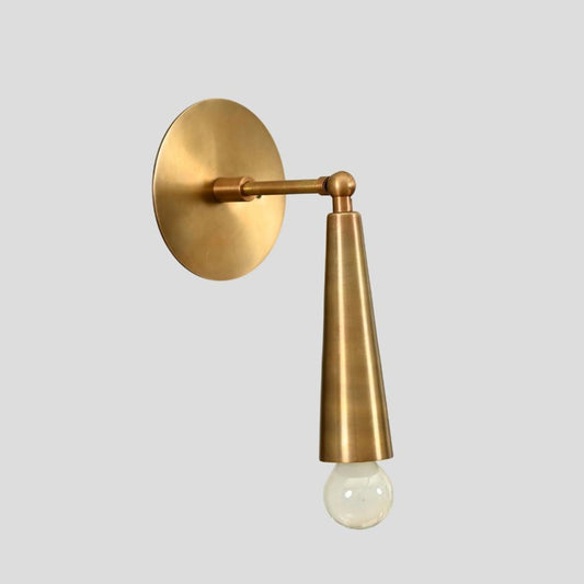 Handmade brass wall sconce with cone shade and exposed bulb, modern industrial wall-mounted light fixture.