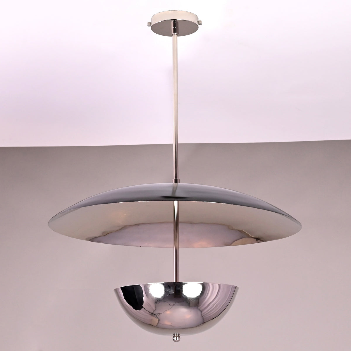 Handmade chrome brass lighting fixture featuring a smooth disc and reflective lower bowl