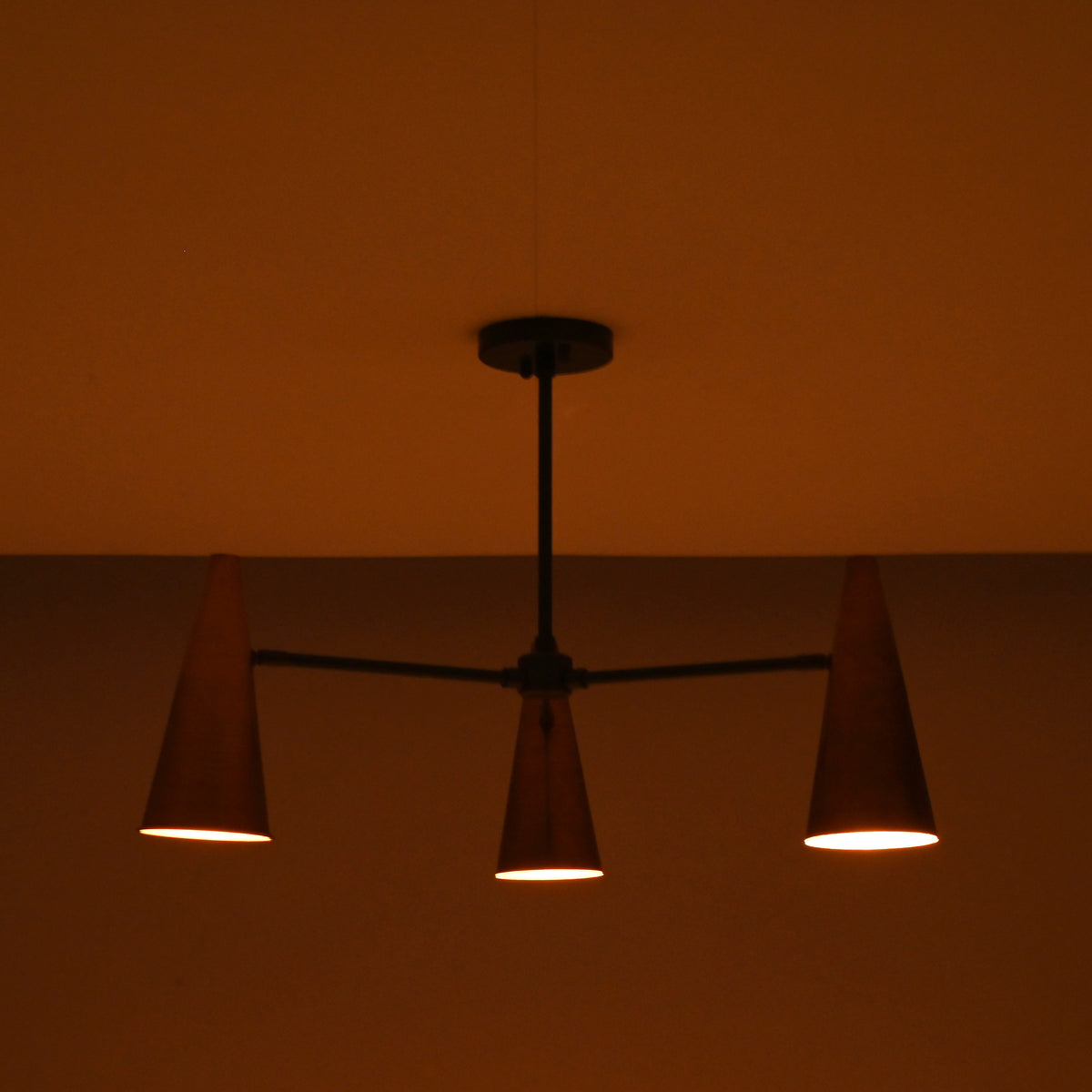 Close-up of handcrafted copper cone shade showing smooth finish and warm interior glow