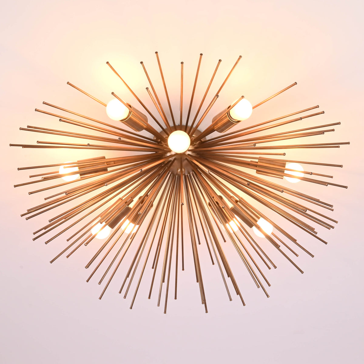 Close view of handmade brass starburst chandelier highlighting precision rods and solid construction