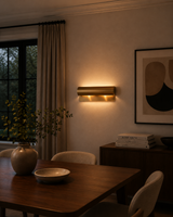 Horizontal cylinder wall light with rounded rectangular backplate and warm side glow detail