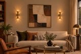 Customizable Ibiza brass wall sconce with perforated hourglass shades, brushed finish and warm ambient lighting