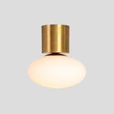 Industrial style brass ceiling light with frosted glass globe, durable handcrafted flush mount lighting by Brass Leaf Studio.