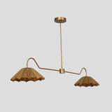 Industrial-inspired handmade brass chandelier with pleated bowl shades, perfect for dining or living areas.
