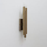 Industrial solid brass tube wall light with vertical cylinder design and exposed bulbs side angle view