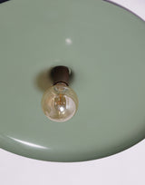 Close-up of brass dome pendant interior showing warm glow and detailed craftsmanship