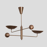 Industrial modern brass chandelier with fluted bowl shades, handmade ceiling fixture blending art and function.
