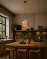 Copper hanging light installed over a kitchen island, creating warm task lighting and elegant ambience