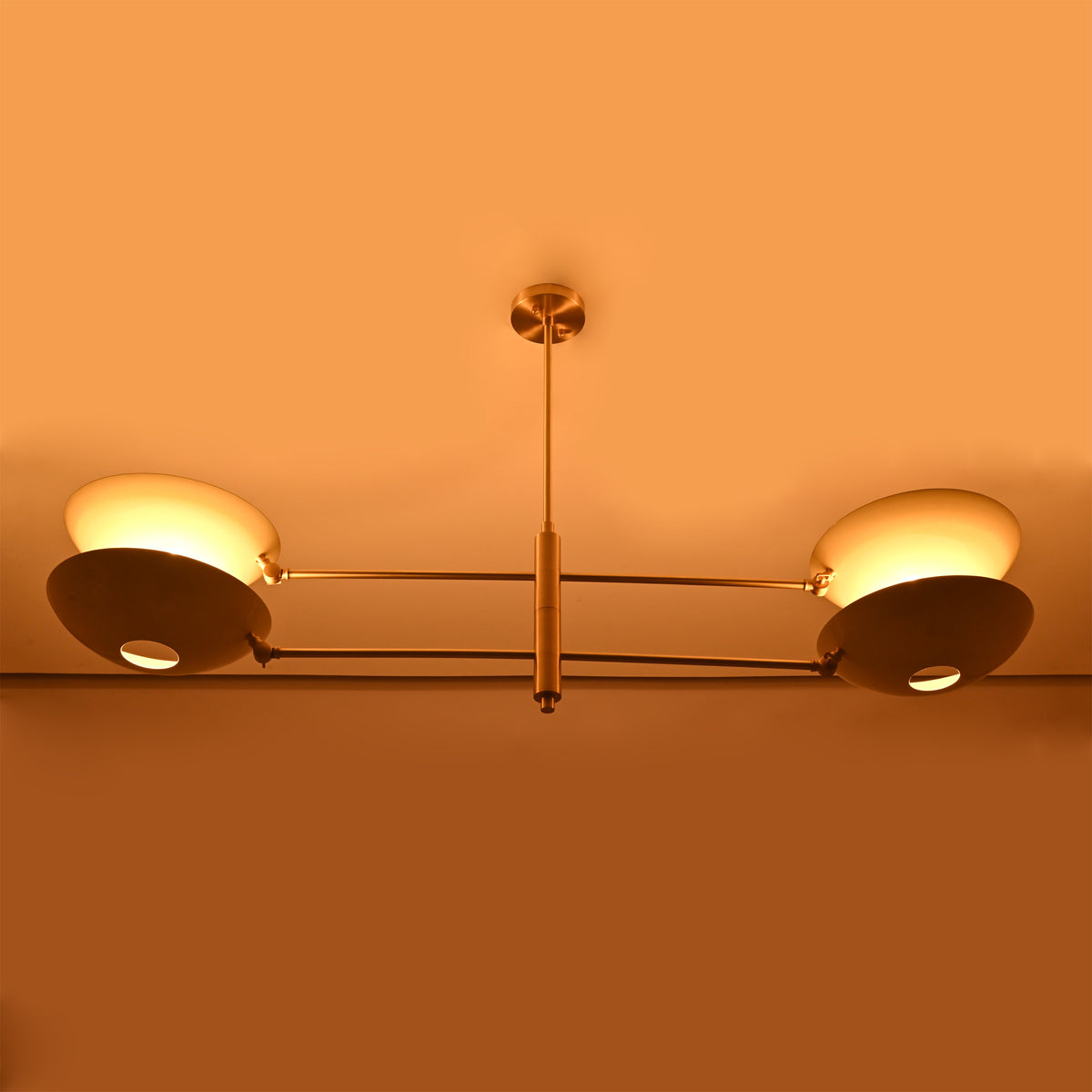 Large 4-light ceiling chandelier installed in a cozy living space with warm glow and refined modern styling