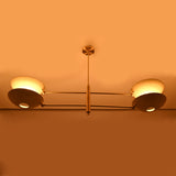 Large 4-light ceiling chandelier installed in a cozy living space with warm glow and refined modern styling