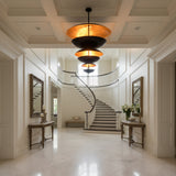 Large 42 inch disc chandelier installed in a modern living room with dramatic stacked saucer design and warm glow