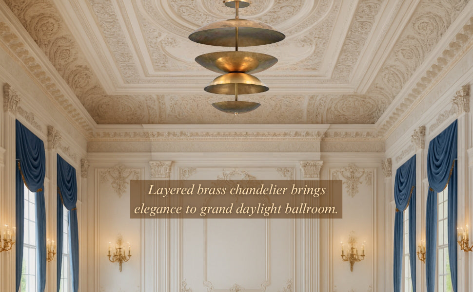 Layered brass chandelier bringing elegance to a grand daylight ballroom with ornate ceiling and tall windows.