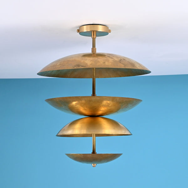 Layered brass disc flush mount ceiling light with sculpted bowl shades, handcrafted in solid brass with warm indirect ambient lighting.