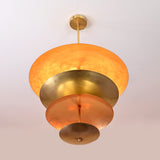 Bottom view of layered brass disc chandelier showing radiant hand-polished reflective surfaces